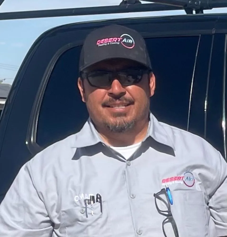 Omar, owner of Desert Air Heating & Cooling, in front of the company truck